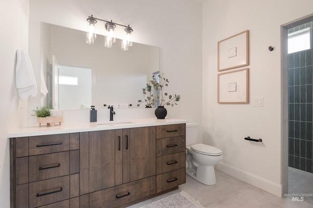 24910 Ardmore Ct, Caldwell, ID 83607 - bathroom featuring vanity, baseboards, toilet, and tiled shower