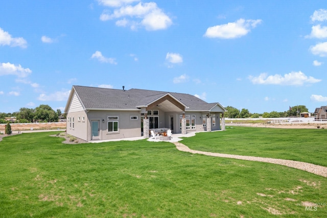24910 Ardmore Ct, Caldwell, ID 83607 - back of house with a patio, a yard, and stucco siding