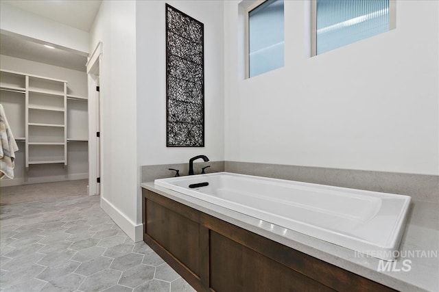 bathroom featuring tile patterned floors and a bathtub