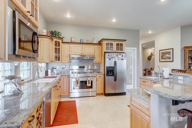 1795 W Black Canyon Hwy, Emmett, ID 83617 - kitchen with under cabinet range hood, appliances with stainless steel finishes, a sink, and light brown cabinets