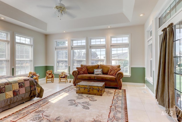 1795 W Black Canyon Hwy, Emmett, ID 83617 - living area with baseboards, a ceiling fan, a raised ceiling, and light tile patterned flooring