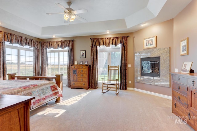 1795 W Black Canyon Hwy, Emmett, ID 83617 - bedroom featuring ceiling fan, light colored carpet, a high end fireplace, baseboards, and a tray ceiling