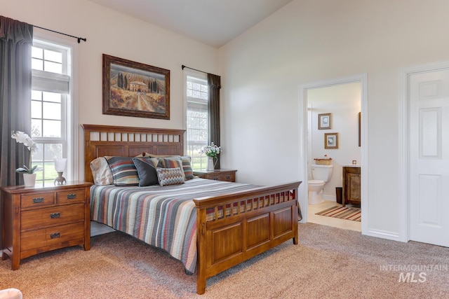 1795 W Black Canyon Hwy, Emmett, ID 83617 - bedroom featuring connected bathroom, light colored carpet, and multiple windows