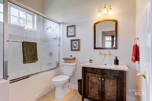 1795 W Black Canyon Hwy, Emmett, ID 83617 - bathroom featuring vanity, combined bath / shower with glass door, toilet, and a wealth of natural light