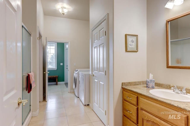 1795 W Black Canyon Hwy, Emmett, ID 83617 - full bathroom featuring vanity, tile patterned floors, a shower with shower door, and washing machine and dryer