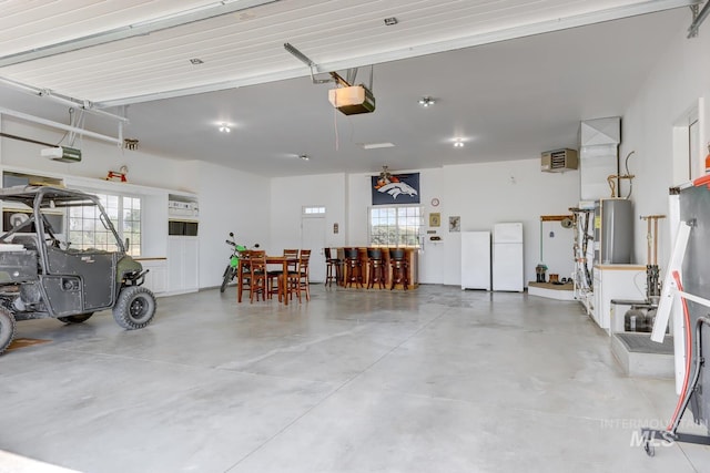 1795 W Black Canyon Hwy, Emmett, ID 83617 - garage featuring freestanding refrigerator, a garage door opener, and gas water heater