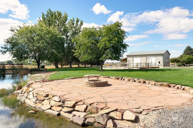 1795 W Black Canyon Hwy, Emmett, ID 83617 - exterior space with a detached garage, an outbuilding, a lawn, a patio, and a fire pit