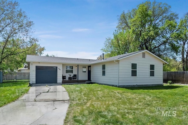 single story home featuring concrete driveway, fence, a front lawn, and a garage