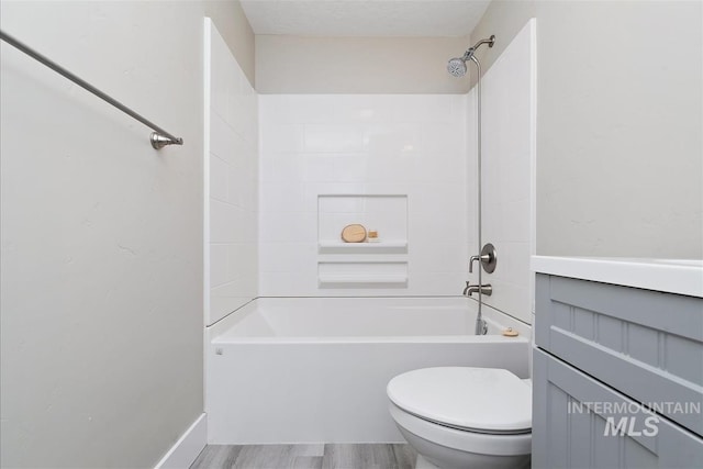 full bathroom with toilet, shower / tub combination, and wood finished floors