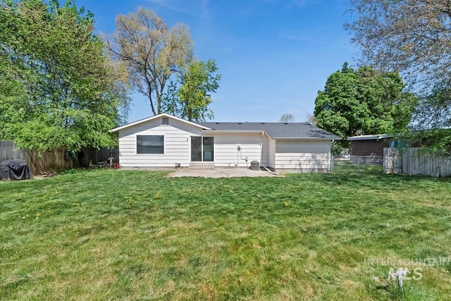 back of property featuring a fenced backyard, a patio, and a lawn