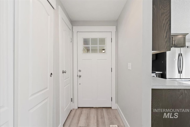entryway featuring light wood-style floors and baseboards