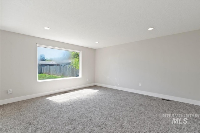 unfurnished room featuring carpet floors, baseboards, recessed lighting, and visible vents