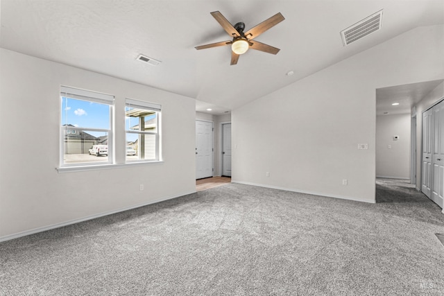 carpeted empty room featuring lofted ceiling, a ceiling fan, recessed lighting, and baseboards