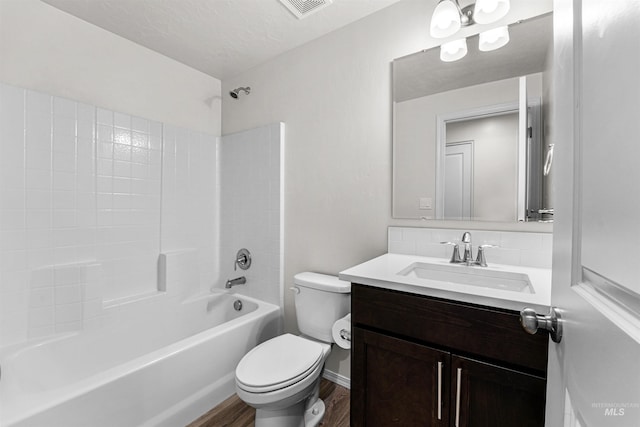 full bathroom featuring wood finished floors, toilet, vanity, and tub / shower combination