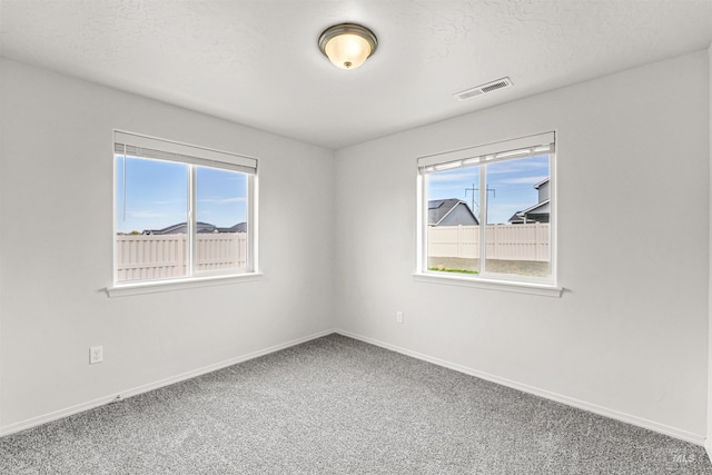 spare room with carpet and baseboards