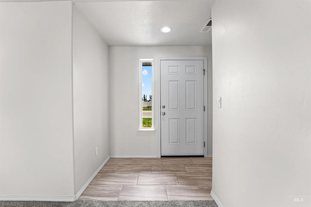 foyer featuring baseboards