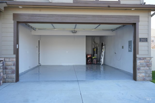 garage featuring a garage door opener and water heater