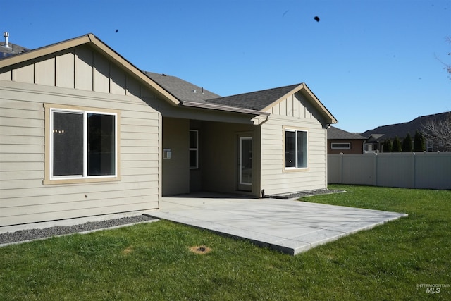 rear view of property featuring a patio area and a yard