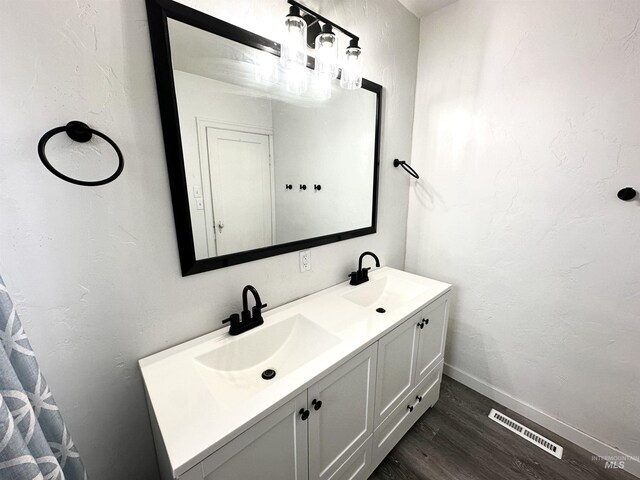 bathroom with vanity and wood-type flooring