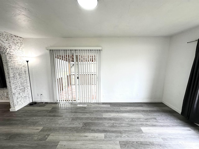 unfurnished room with wood-type flooring