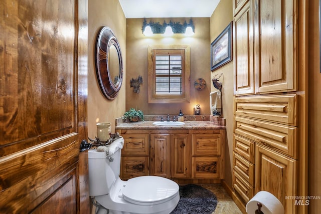 bathroom with toilet and vanity