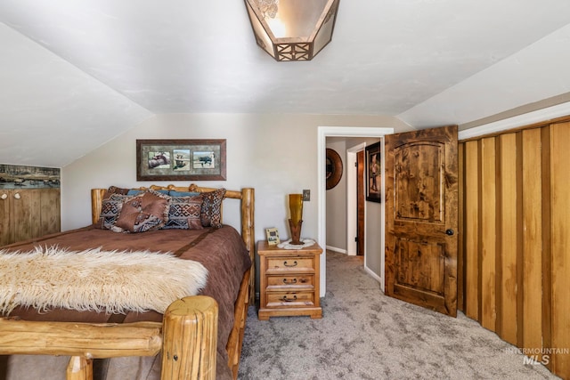 bedroom with carpet and vaulted ceiling