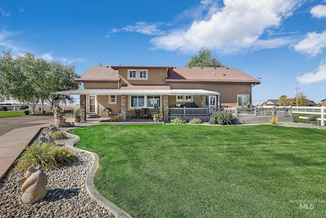 rear view of property with a yard