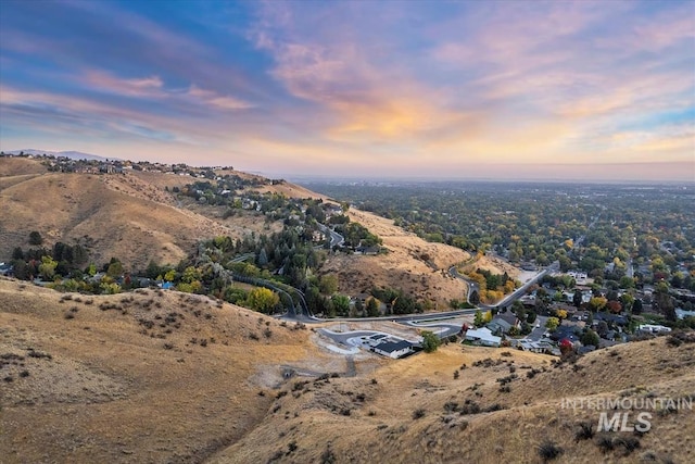 aerial view at dusk featuring a mountain view