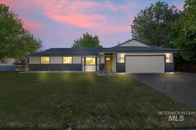 ranch-style home featuring concrete driveway and an attached garage