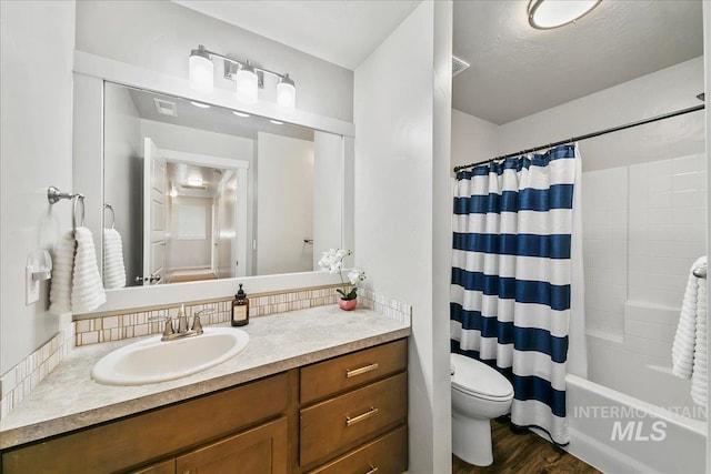 full bathroom with toilet, shower / tub combo, wood-type flooring, vanity, and backsplash