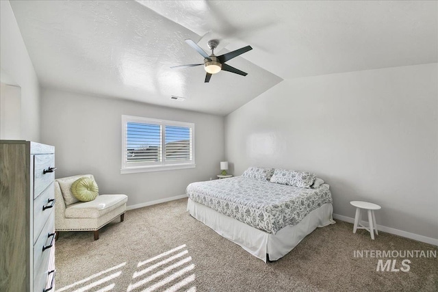 bedroom featuring carpet flooring, vaulted ceiling, and ceiling fan