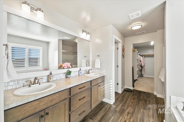 bathroom with hardwood / wood-style flooring and vanity