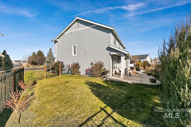 rear view of property with a patio area and a lawn