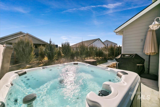 view of swimming pool with a hot tub and area for grilling