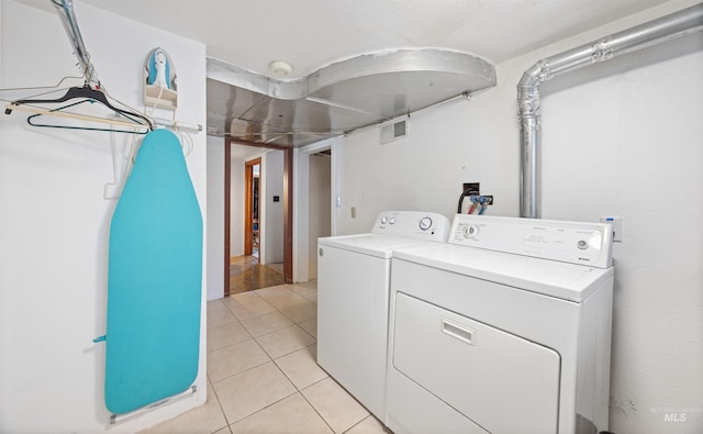 209 N Canyon St, Nampa, ID 83651 - laundry room featuring washer and dryer and light tile patterned flooring