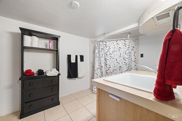 209 N Canyon St, Nampa, ID 83651 - full bath with tile patterned flooring, vanity, a textured ceiling, and curtained shower