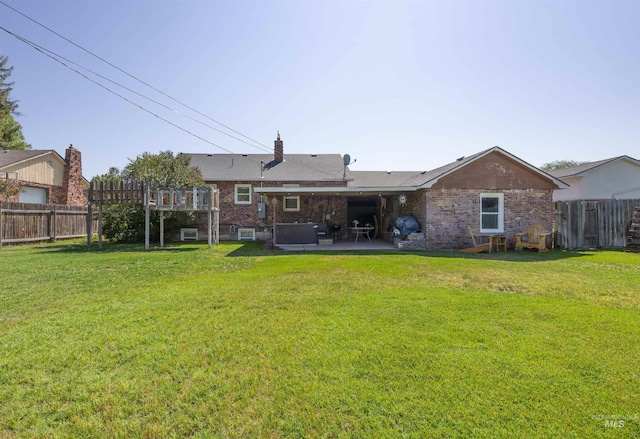 209 N Canyon St, Nampa, ID 83651 - back of house featuring a patio, brick siding, and a chimney