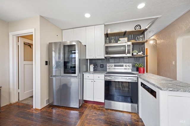 209 N Canyon St, Nampa, ID 83651 - kitchen featuring appliances with stainless steel finishes, dark wood-type flooring, white cabinetry, decorative backsplash, and open shelves