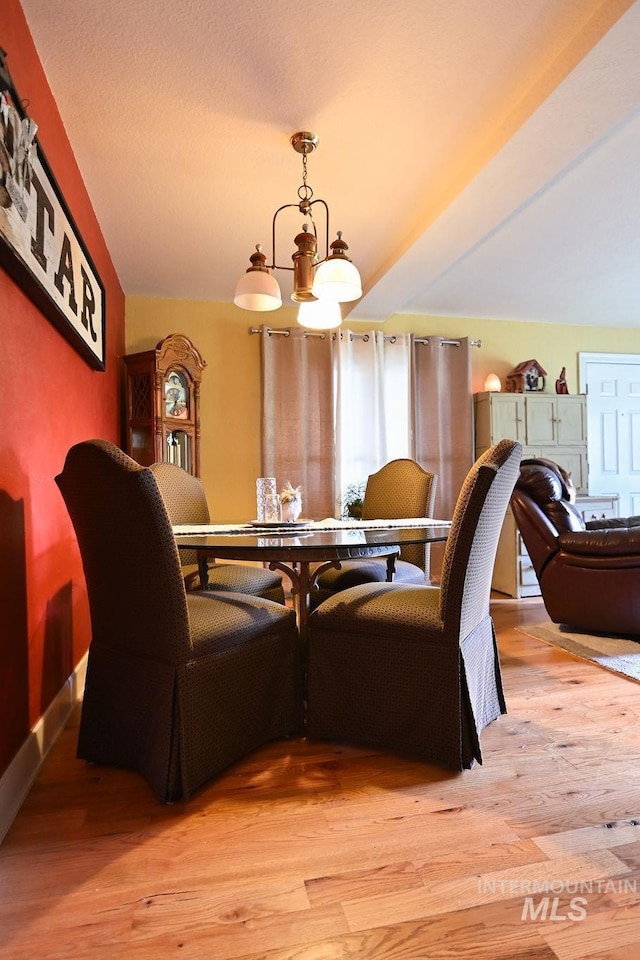 221 N Union St, Star, ID 83669 - dining area featuring a chandelier, light wood-type flooring, and baseboards