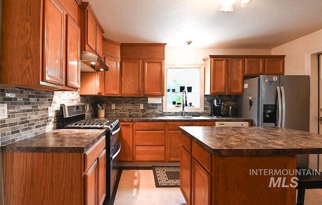 221 N Union St, Star, ID 83669 - kitchen featuring appliances with stainless steel finishes, dark countertops, a sink, and ventilation hood