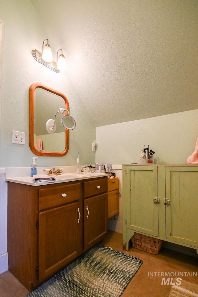 221 N Union St, Star, ID 83669 - bathroom with lofted ceiling, vanity, and a textured ceiling
