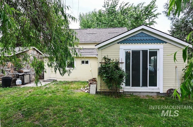 221 N Union St, Star, ID 83669 - back of house with a lawn and roof with shingles