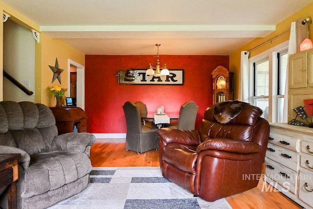 221 N Union St, Star, ID 83669 - living room featuring a chandelier, light wood-style floors, an accent wall, and baseboards