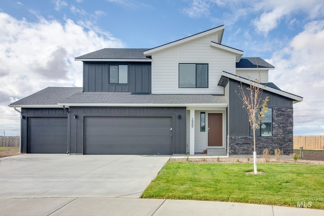 view of front of property featuring a garage and a front lawn