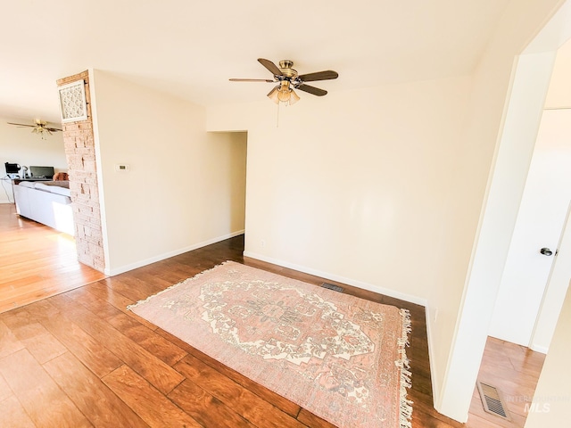 unfurnished room with ceiling fan and hardwood / wood-style floors