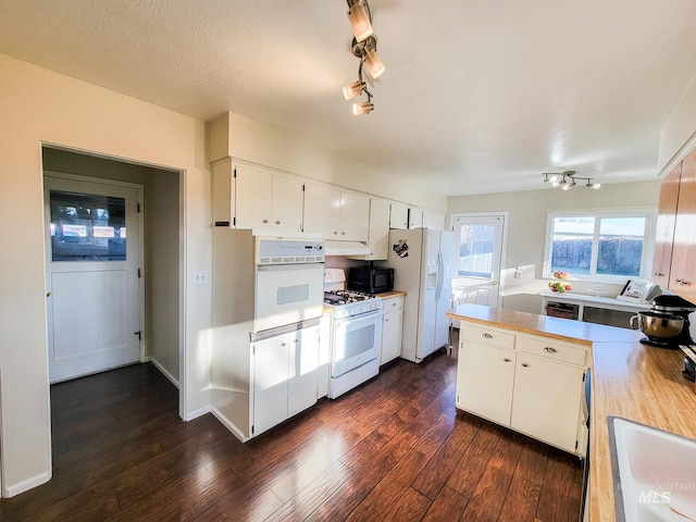 kitchen featuring sink, white cabinets, white appliances, dark wood-type flooring, and a textured ceiling