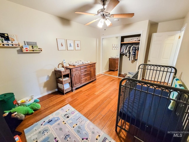 bedroom featuring hardwood / wood-style flooring, ceiling fan, and a closet