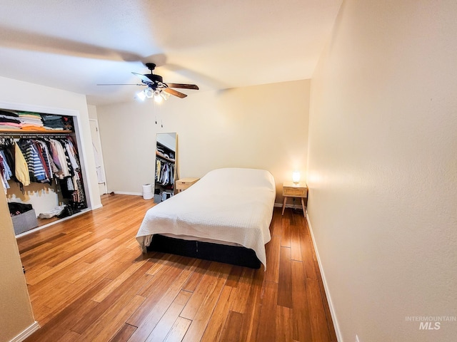 bedroom featuring hardwood / wood-style flooring, a closet, and ceiling fan