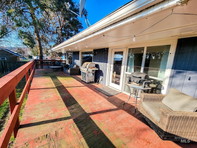 view of patio featuring a wooden deck, grilling area, and outdoor lounge area