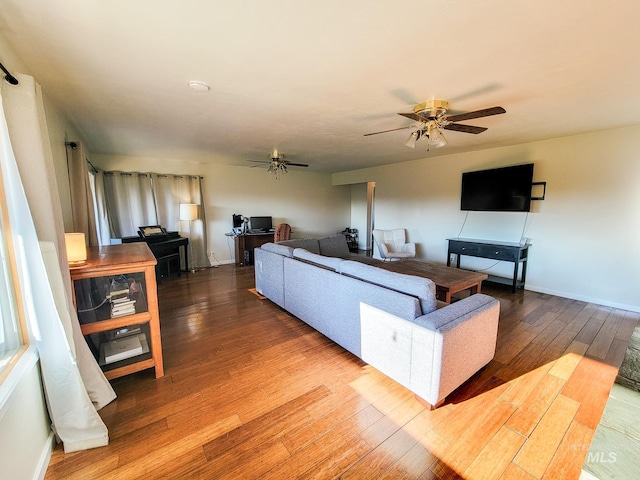 living room featuring ceiling fan and wood-type flooring